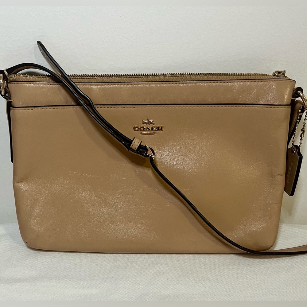 Coach Crossbody - Tan with gold hardware and adjustable strap.